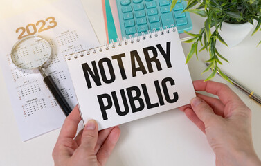 Naklejka na ściany i meble NOTARY PUBLIC is written in a white notepad near a calculator, coffee, glasses and a pen. Business concept