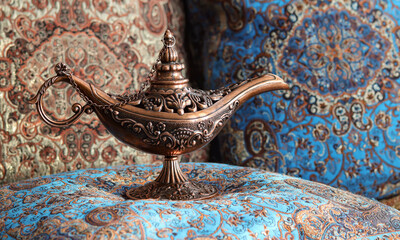 Beautiful oriental lamp made of metal with carved patterns. Oriental Aladin Lamp.