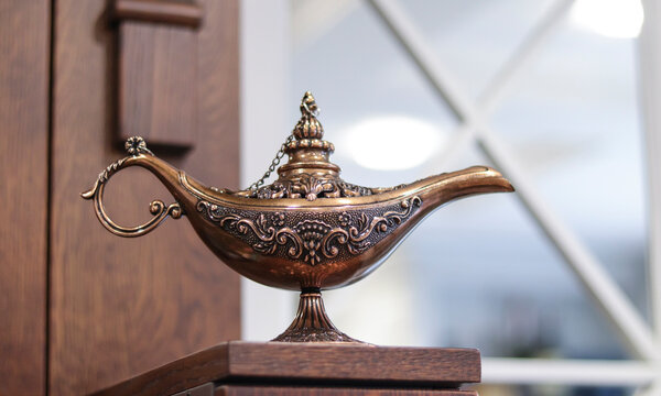 Beautiful oriental lamp made of metal with carved patterns. Oriental Aladin Lamp.