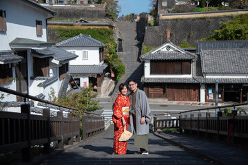 Couple in love wearing Traditional Japanese Kimono and Samurai clothes at the old town in Kitsuki, Japan