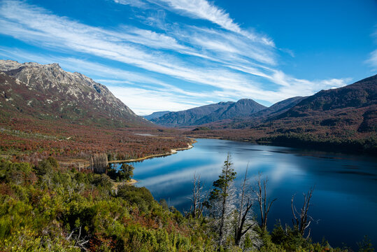 View of the Andean mountains reflected on Lake Los Moscos, in the Nahuel Huapi National Park, Argentina, in autumn.