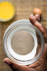 Instant dry yeast in a glass bowl, top view of dry yeast granules in a small bowl, yeast for baking