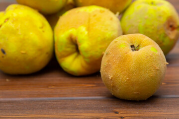 Quince fruit close-up on a wooden background.