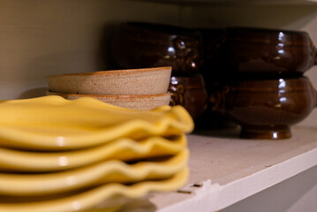 Bowls and plates on a kitchen self