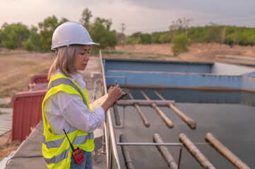 Environmental engineers work at wastewater treatment plants,Water supply engineering working at Water recycling plant for reuse,Technicians and engineers discuss work together.