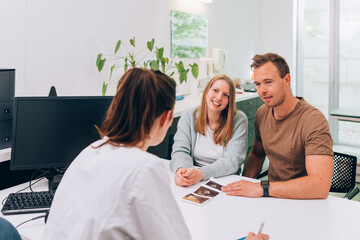 couple with pregnant woman to the doctor for medical examination