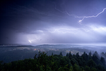 Naklejka na ściany i meble Lightning strike during a summer thunderstorm in the upper Rhine valley and the northern Black Forest