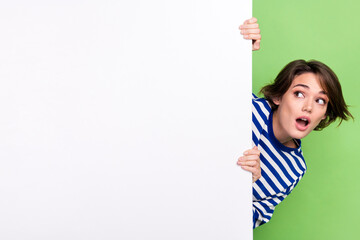 Photo of young girl hide big board playful unexpected reaction open mouth look promo empty space...
