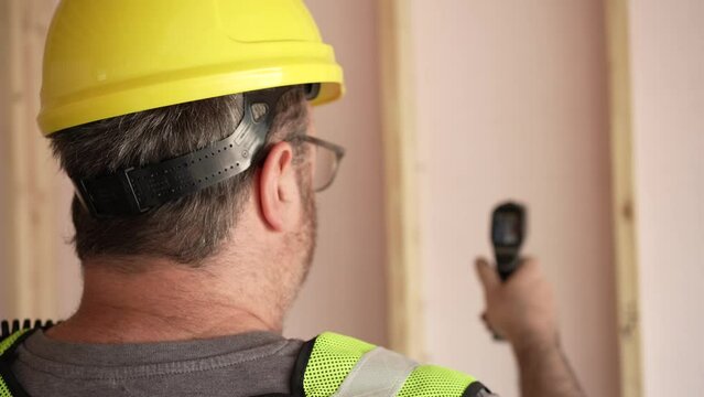 Worker Using Infrared Thermometers For Industrial Job