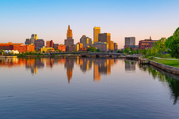 Providence downtown skyline and buildings at sunrise, tranquil water reflections over the River in the capital city of Rhode Island