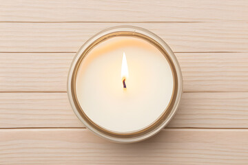 Obraz na płótnie Canvas Burning candle on a wooden background top view ai generative