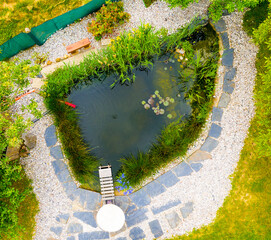 Garden pond. Relaxation zone with fish farming in an organic orchard from above. Sustainable development in gardening and aquaculture.
- 608752183