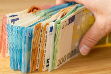 Bundles of euro money, bundle of banknotes held in a hand, Financial concept, Euro zone, Currency...