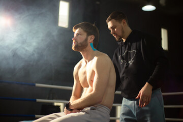 A sports massage therapist performs massage and taping