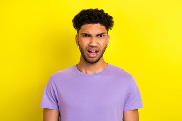 Photo of shocked confused guy dressed purple t-shirt open mouth isolated yellow color background