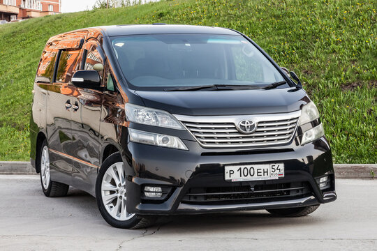 Front View of Toyota Vellfire japanese luxury minivan car in black color on the parking with seven passenger seats.