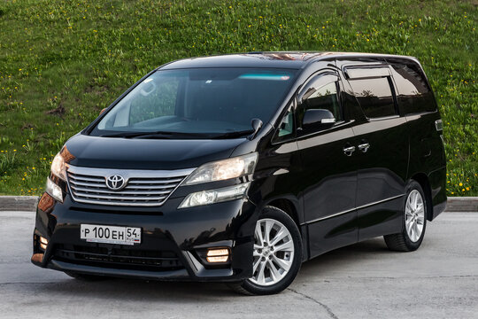 Front View of Toyota Vellfire japanese luxury minivan car in black color on the parking with seven passenger seats.