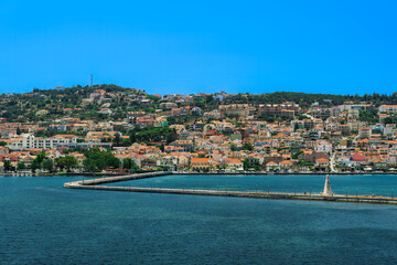 1813 stone-built water-surrounded obelisk next to De Bosset Bridge with Argostoli town panorama in the background on the Ionian Island of Cephalonia Greece.