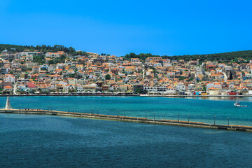 Fototapeta premium 1813 stone-built water-surrounded obelisk next to De Bosset Bridge with Argostoli town panorama in the background on the Ionian Island of Cephalonia Greece.