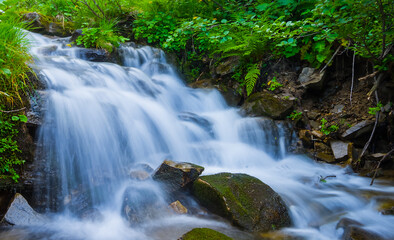 Obraz premium closeup small waterfall on mountain river