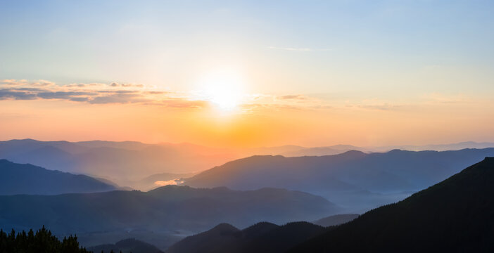 mountain valley in blue mist at the sunrise