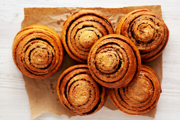 Homemade Cinnamon Roll Pastry on a white wooden background, top view. Flat lay, overhead, from above.