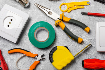 Electrician equipment on marble background with copy space.Top view.Electrician tool set.Multimeter, tester,screwdrivers,cutters,duct tape,lamps,tape measure and wires.Flet lay. © Avocado_studio