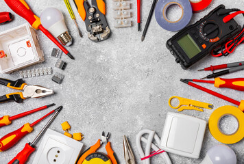 Electrician equipment on marble background with copy space.Top view.Electrician tool set.Multimeter, tester,screwdrivers,cutters,duct tape,lamps,tape measure and wires.Flet lay. © Avocado_studio