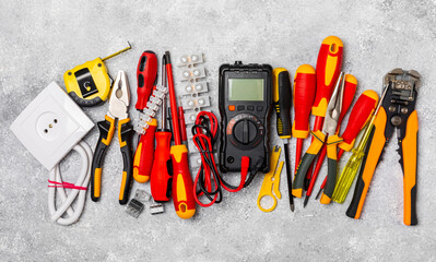 Electrician equipment on marble background with copy space.Top view.Electrician tool set.Multimeter, tester,screwdrivers,cutters,duct tape,lamps,tape measure and wires.Flet lay. © Avocado_studio