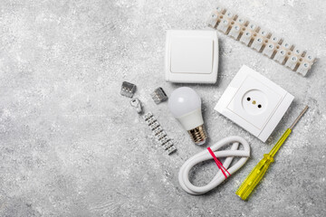 Electrician equipment on marble background with copy space.Top view.Electrician tool set.Multimeter, tester,screwdrivers,cutters,duct tape,lamps,tape measure and wires.Flet lay. © Avocado_studio