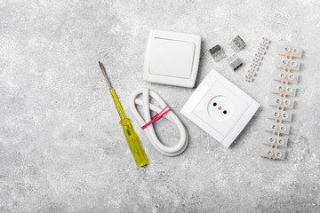 Electrician equipment on marble background with copy space.Top view.Electrician tool set.Multimeter, tester,screwdrivers,cutters,duct tape,lamps,tape measure and wires.Flet lay. © Avocado_studio