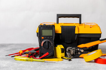 Electrician equipment on marble background with copy space.Top view.Electrician tool set.Multimeter, tester,screwdrivers,cutters,duct tape,lamps,tape measure and wires.Flet lay. © Avocado_studio