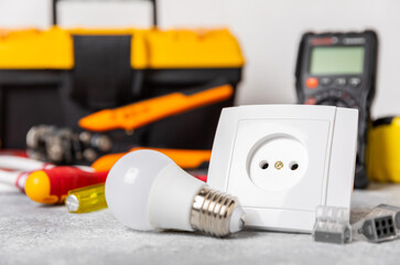 Electrician equipment on marble background with copy space.Top view.Electrician tool set.Multimeter, tester,screwdrivers,cutters,duct tape,lamps,tape measure and wires.Flet lay. © Avocado_studio
