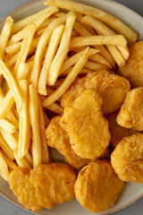 Homemade Chicken Nuggets and French Fries with Ketchup on gray background, top view. Flat lay, overhead, from above.