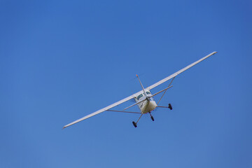 Fototapeta na wymiar Cessna light aircraft ever built with overhead wing and single propellarin the blue sky