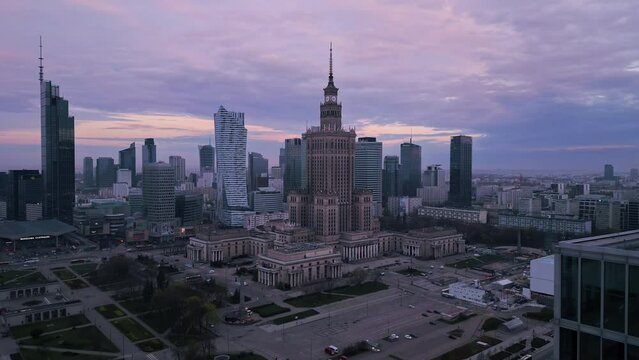 warsaw modern town aerial view at sunrise drone flying out the open window over city center at dawn
