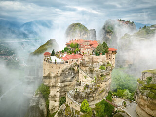 Meteora Varlaam Monastery rising out of the mist. Amazing mystical landscape.  A UNESCO heritage site. Meteora mountains, Thessaly, Greece.