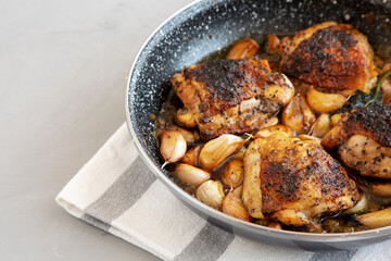 Homemade Chicken With 40 Cloves of Garlic on a Plate, side view. Copy space.