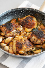 Homemade Chicken With 40 Cloves of Garlic on a Plate, side view. Close-up.