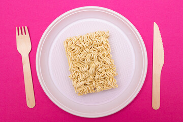 Uncooked Instant Noodles on White Plate. Raw Pasta. Dry Asian Fast Food. Quick Lunch