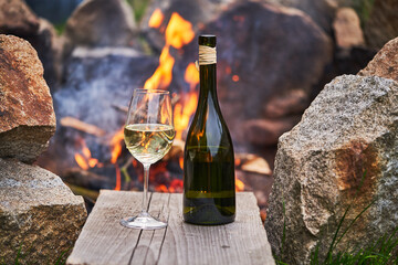 Romantic picture of the glass of white wine and rustic style bottle from small family winery in...