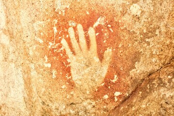 Photo of a handprint on a rock in Cueva de las Manos, Argentina