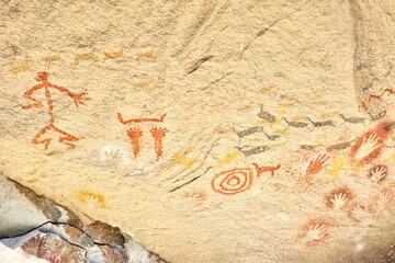 Photo of Rock with ancient paintings of people and animals found in Cueva de las Manos, Argentina