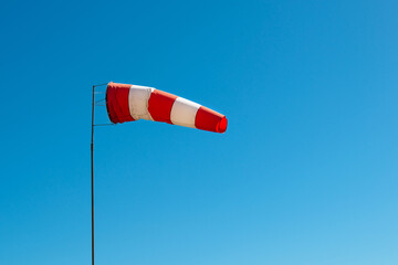 A windsock (also called a wind cone) shows the wind direction at the airport. Conical textile tube...