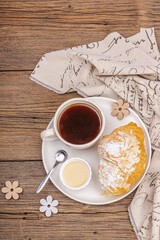 Good morning concept. Breakfast with cup of coffee and fresh croissant. Sweet creamy sauce