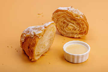 Good morning concept. Fresh croissants with cream filling and almond flakes. Sweet dessert