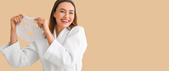 Young woman with sheet facial mask on beige background with space for text