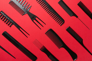 Professional combs and hairdresser tools on color background, top view