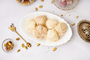 Plate with tasty Turkish Pismaniye on light background