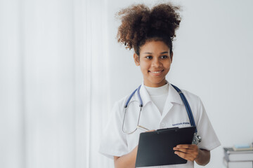 Doctor and patient sitting and talking at medical examination at hospital office, close-up. Therapist filling up medication history records. Medicine and healthcare concept.